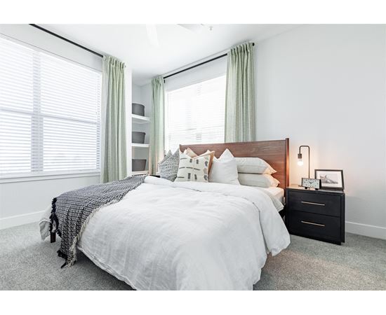 a bedroom with two windows and a bed with a white comforter and pillows at RockVue, Broomfield, 80021